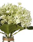Artificial white flower arrangement in a glass vase by Heaven Sends, showcasing delicate blossoms and lush greenery.