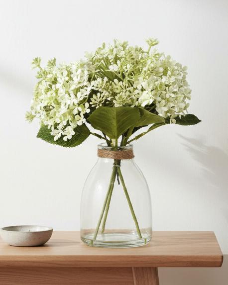 Artificial white flower arrangement in a clear glass vase, crafted by Heaven Sends, perfect for elegant home decor.