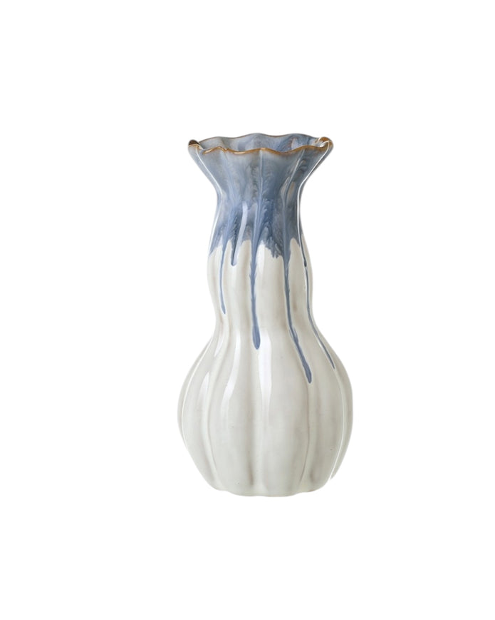 Blue and white ceramic vase by Heaven Sends with intricate patterns, displayed on a neutral background.