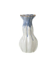 Blue and white ceramic vase by Heaven Sends with intricate patterns, displayed on a neutral background.