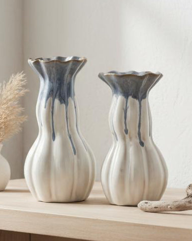 Blue and white ceramic vase with intricate patterns, designed by Heaven Sends, displayed on a neutral surface.