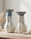 Blue and white ceramic vase with intricate patterns, designed by Heaven Sends, displayed on a neutral surface.