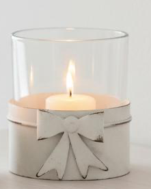 White metal bow hurricane candle holder with tealight inside, decorative home décor piece by Heaven Sends.