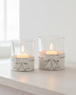 White metal bow hurricane candle holder for tealights, decorative home décor piece by Heaven Sends.