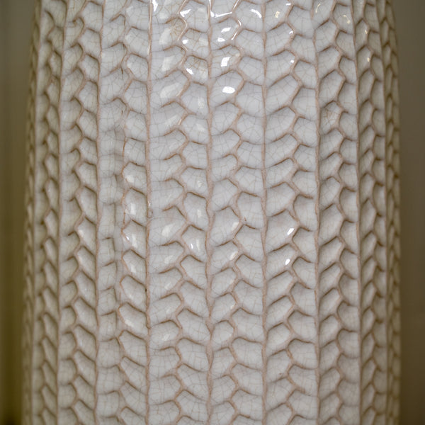 White leaf-patterned ceramic vase with a glossy finish and narrow bottle-shaped neck