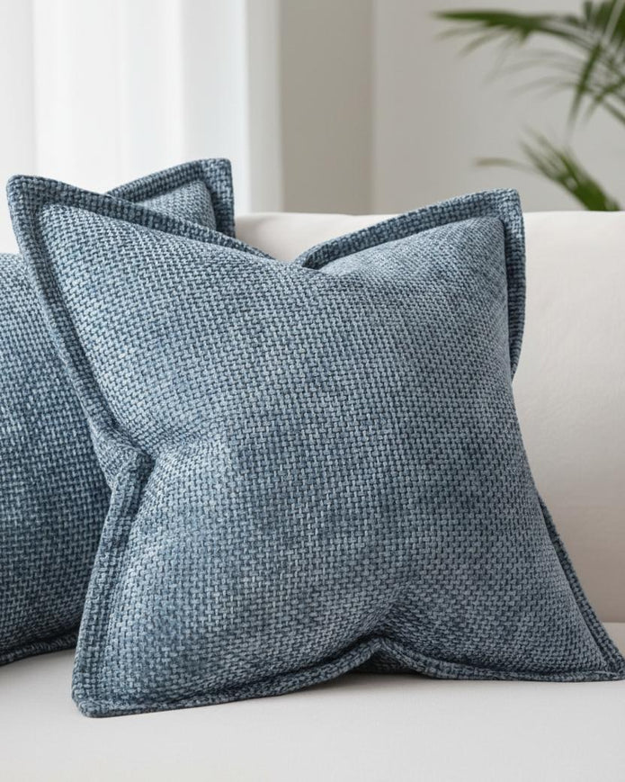 Denim blue woven design cushion cover with soft furnishings edge by Starlight Express, showing textured fabric and decorative stitching.