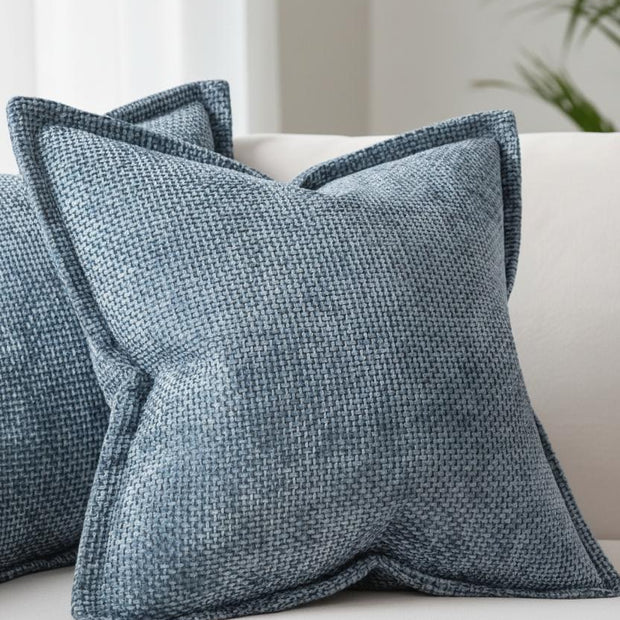 Denim blue woven design cushion cover with soft furnishings edge by Starlight Express, showing textured fabric and decorative stitching.