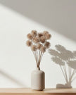 Artificial brown neutral pom pom stem from Coach House, showcasing soft, fluffy pom poms on a realistic plant stem.
