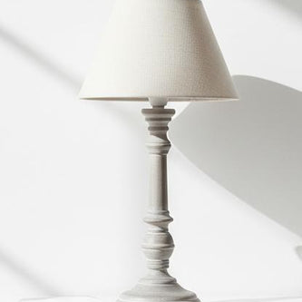 Pella wooden table lamp by Hill Interiors with a classic design, featuring a smooth wooden base and fabric lampshade.