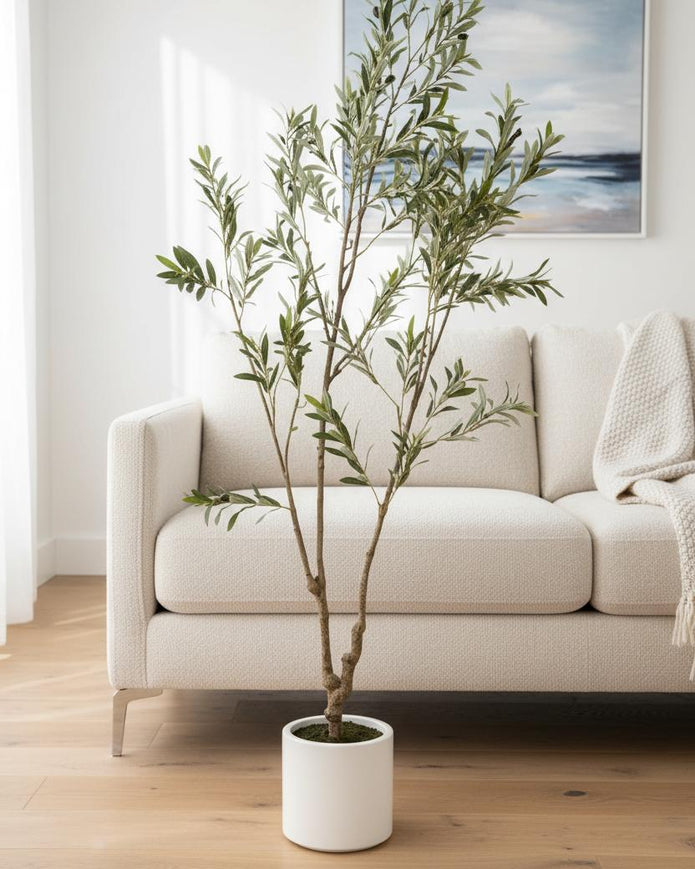 Medium artificial faux olive tree by Hill Interiors, showcasing realistic green leaves and a sturdy trunk for home decor.