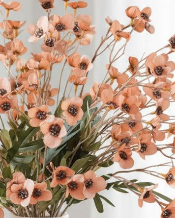 Artificial orange daisy flower stem from Starlight Express, showcasing vibrant petals and green leafy stems.