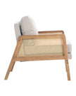 Beige linen upholstered rattan armchair with a natural wood frame, styled for a cozy living room setting.