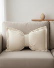 Cream neutral corduroy striped bow cushion from Starlight Express, soft furnishings with a plush, textured fabric and decorative bow.
