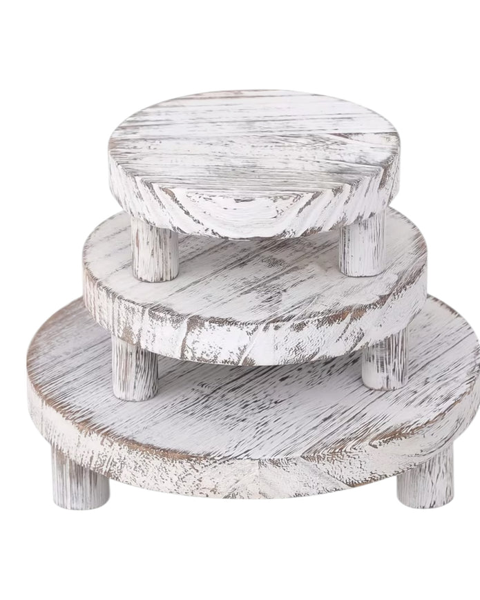 Set of three white washed round risers for home decor displays by Starlight Express, featuring natural wood finish and varying heights.