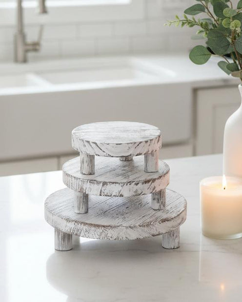 Set of three white washed round risers for home decor, featuring natural wood finish and versatile display surfaces.