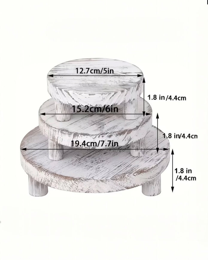 Set of three white washed round risers for home decor, featuring natural wood finish and versatile display options.