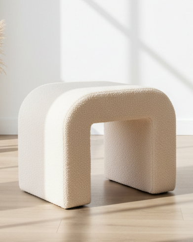 Cream boucle arched foot stool from Starlight Express, plush fabric, stylish furniture piece with curved design and sturdy base.