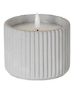 Natural Stone Ribbed Light Up LED Candle for home decor by Hill Interiors, glowing with a warm, ambient light.