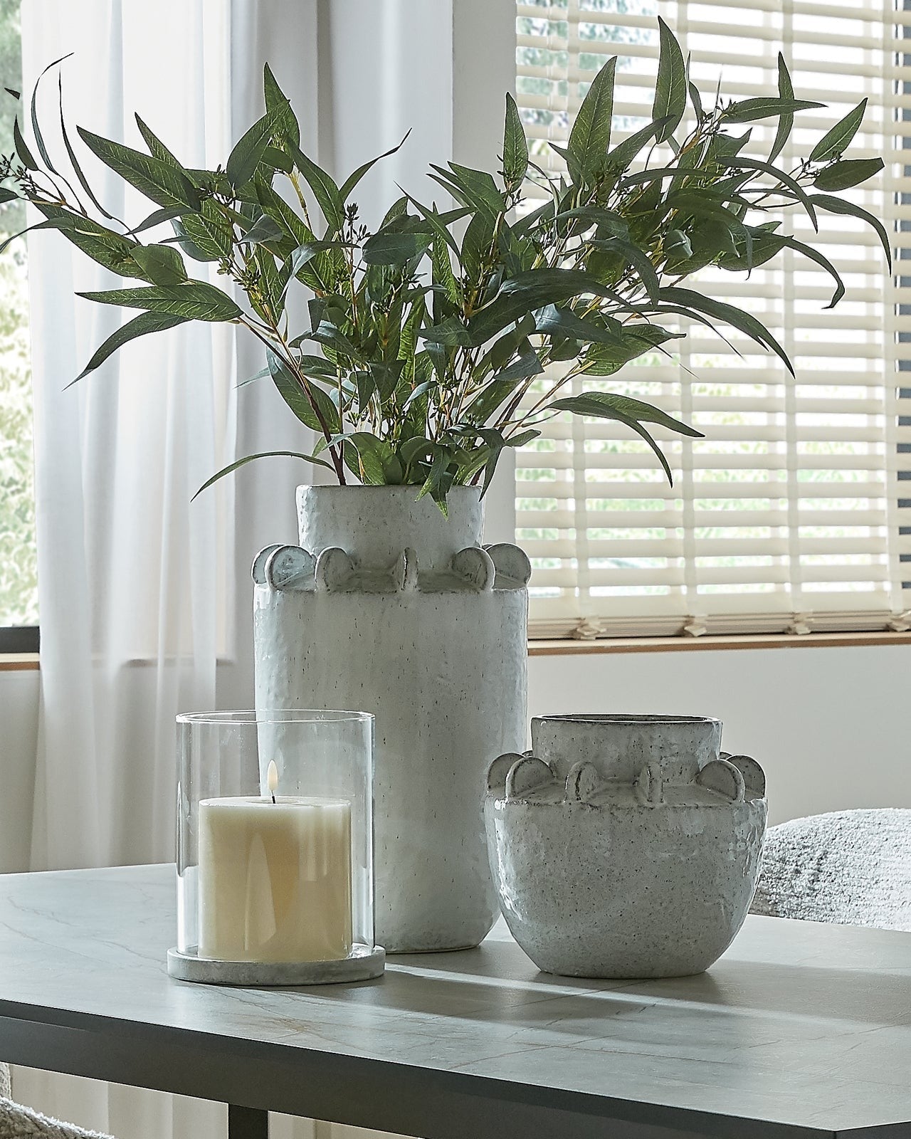 White ceramic Dara wide neck textured vase by Hill Interiors, showcasing its modern design and detailed surface finish.