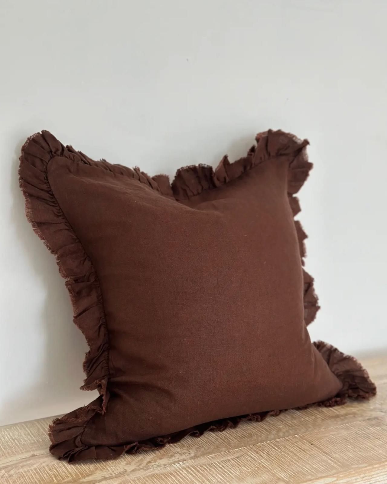 Dark brown linen blend cushion cover with ruffle square design, soft furnishings by Ellenvale Trade, shown on a cozy sofa.