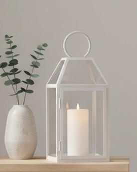 White LED light-up pillar candle from Hill Interiors, glowing with a soft, flickering light, ideal for decorative candle displays.