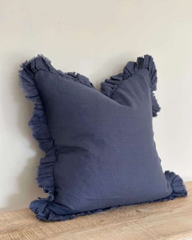 Navy blue linen cushion cover with ruffled edge from Ellenvale Trade, soft furnishings decor, showcasing elegant textured fabric.