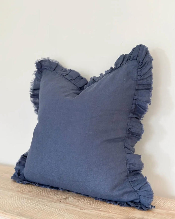 Navy blue linen cushion cover with ruffled edges, soft furnishings by Ellenvale Trade, showcasing elegant, textured fabric design.