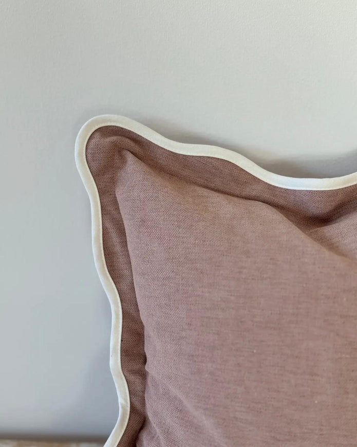 Dusty pink square scalloped cushion cover by Ellenvale Trade, soft furnishings with decorative scalloped edges.