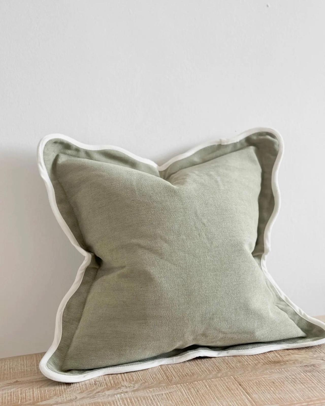 Chloe extra large sage green square cushion cover with scalloped edges, soft furnishings by Ellenvale Trade, shown on a sofa.