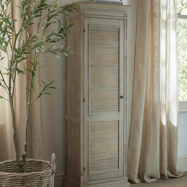 Tall wooden cabinet from Hill Interiors' Delphine Collection with a single door and modern design, ideal for storage and decor.