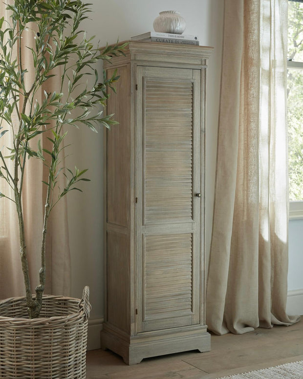 Tall wooden cabinet from Hill Interiors' Delphine Collection with a single door and modern design, ideal for storage and decor.
