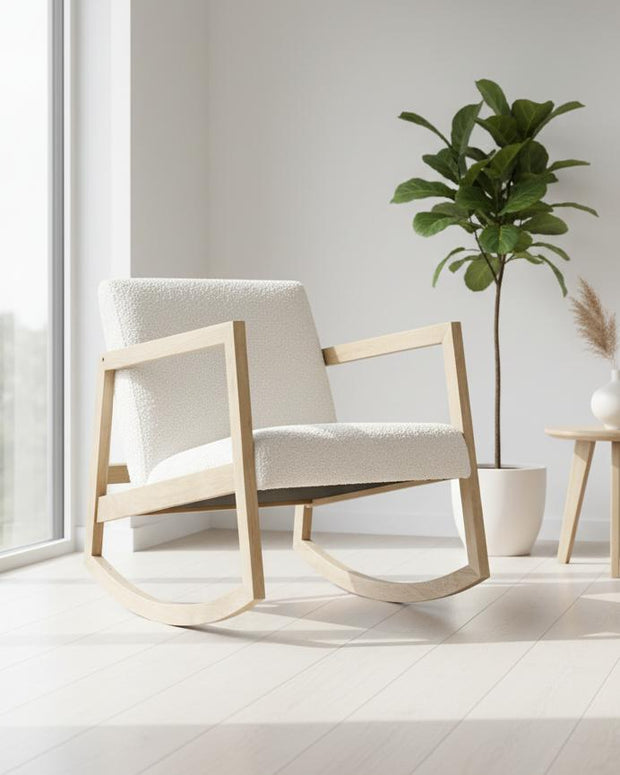Cream boucle Sherpa rocking chair with a plush cushion and wooden rockers, styled with modern furniture design.