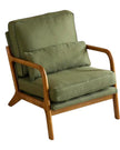 Green retro wooden framed arm chair from Starlight Express with plush upholstery and vintage design in a cozy living space.