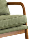 Green retro wooden-framed arm chair from Starlight Express with a vintage design and cushioned seat, displayed in a cozy living room setting.
