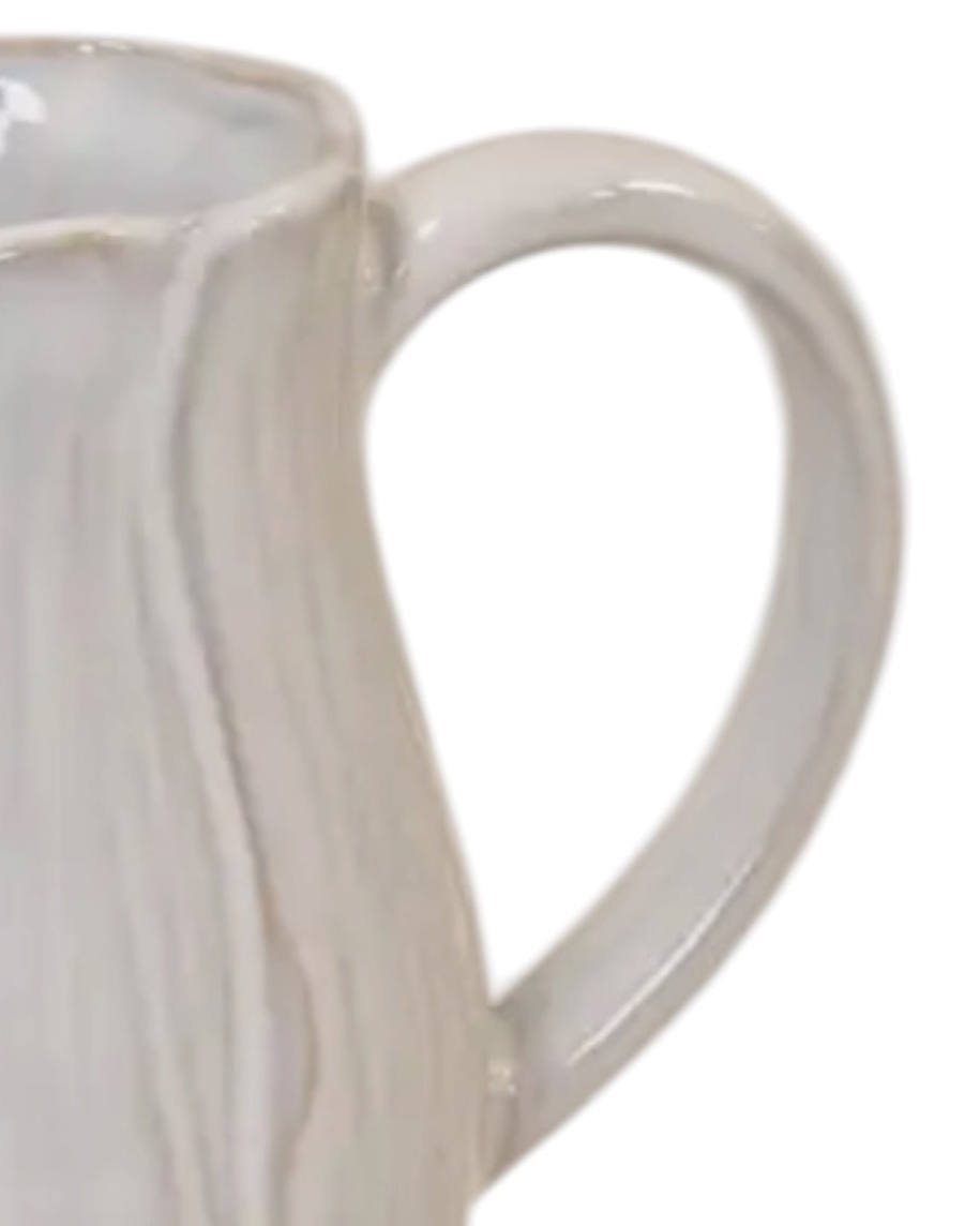 Natural ceramic jug with petal-shaped design, Satchville home decor piece featuring a smooth, elegant finish and floral-inspired shape.