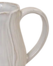 Natural ceramic jug with petal-shaped design, Satchville home decor piece featuring a smooth, elegant finish and floral-inspired shape.