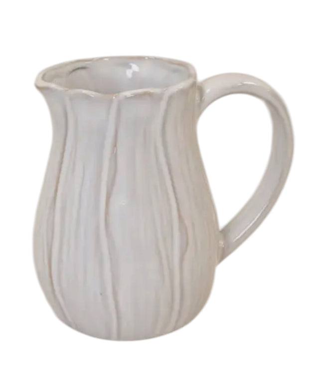 Natural ceramic jug with petal-shaped design, ideal for home decor, by Satchville, featuring a smooth, elegant finish.