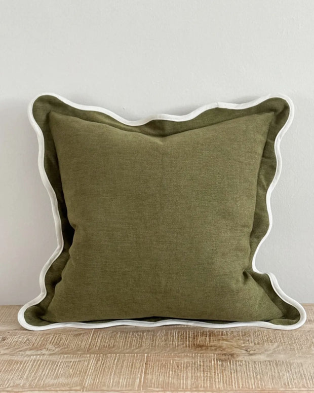Olive green Chloe square cushion cover with scalloped edges, soft furnishings by Ellenvale Trade, displayed on a sofa.