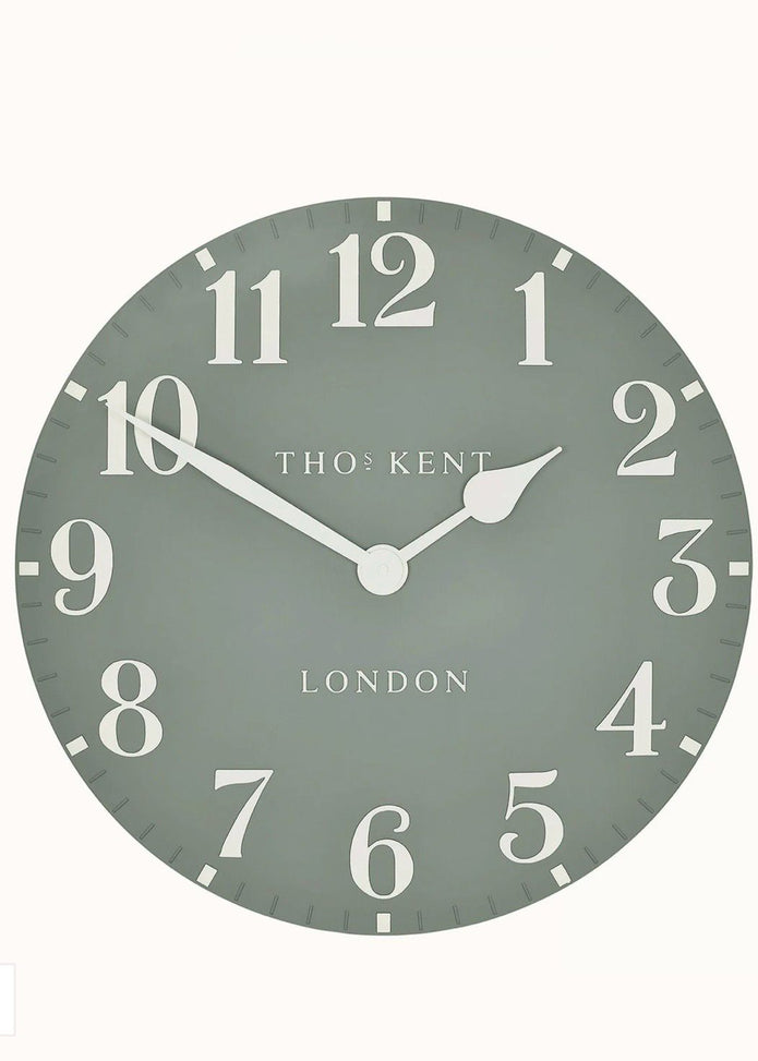 Gallery Direct Thomas Kent 12-inch Arabic wall clock in seagrass green with bold black Arabic numerals and modern design.