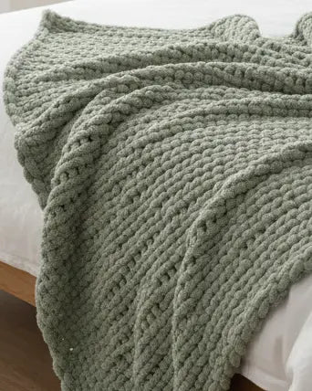 Sage green chunky chenille knit throw blanket from Starlight Express, soft and cozy for home decor or lounging.