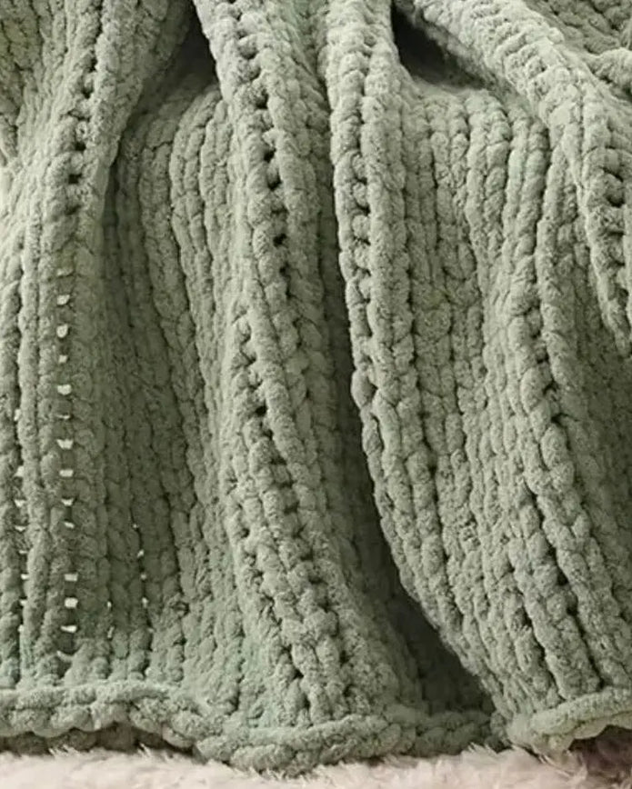 Sage green chunky chenille knit throw blanket from Starlight Express, soft and cozy for living room or bedroom decor.