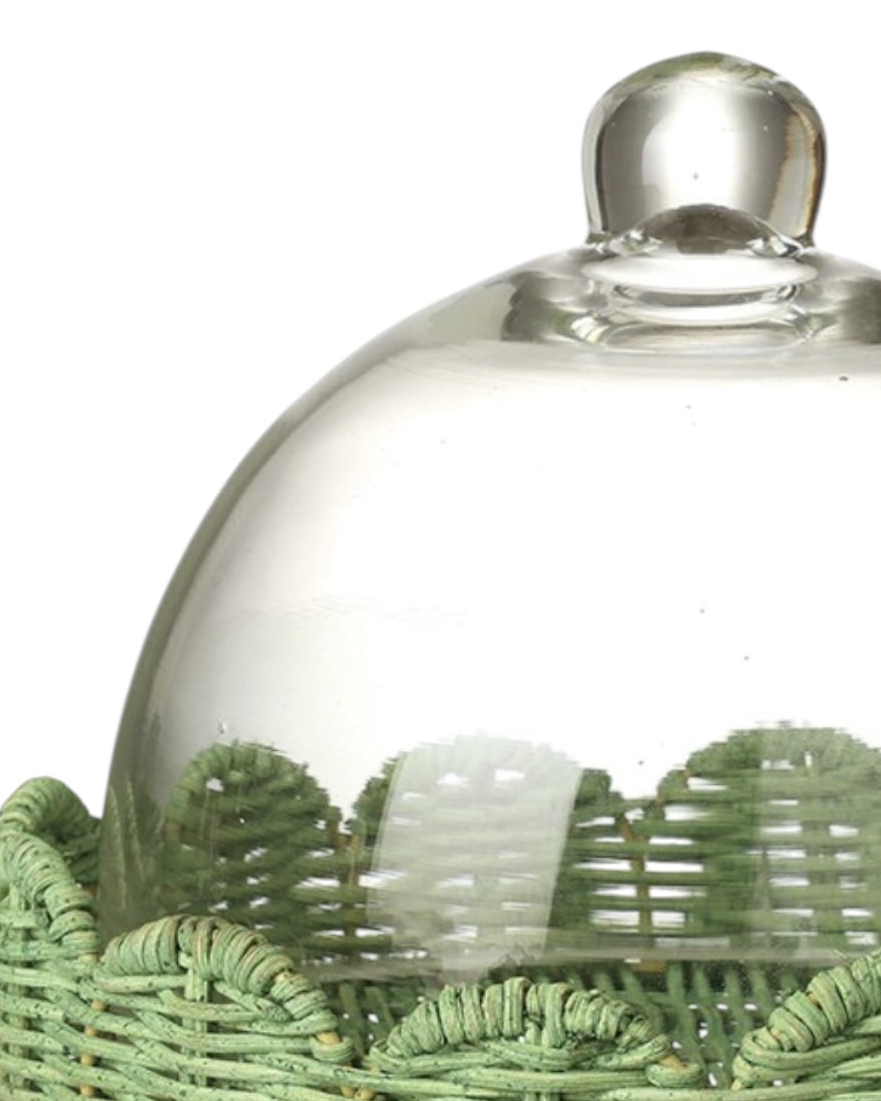 Glass cloche on footed green scalloped wicker base, decorative display dome from Heaven Sends.