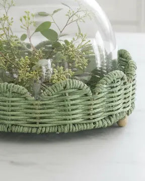 Glass cloche with footed green scalloped wicker base, decorative display cover from Heaven Sends.