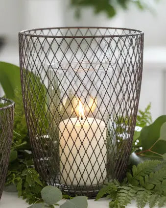 Set of two rust wire hurricane candle holders by Terrace & Garden Ltd, featuring rustic metal design for home decor.