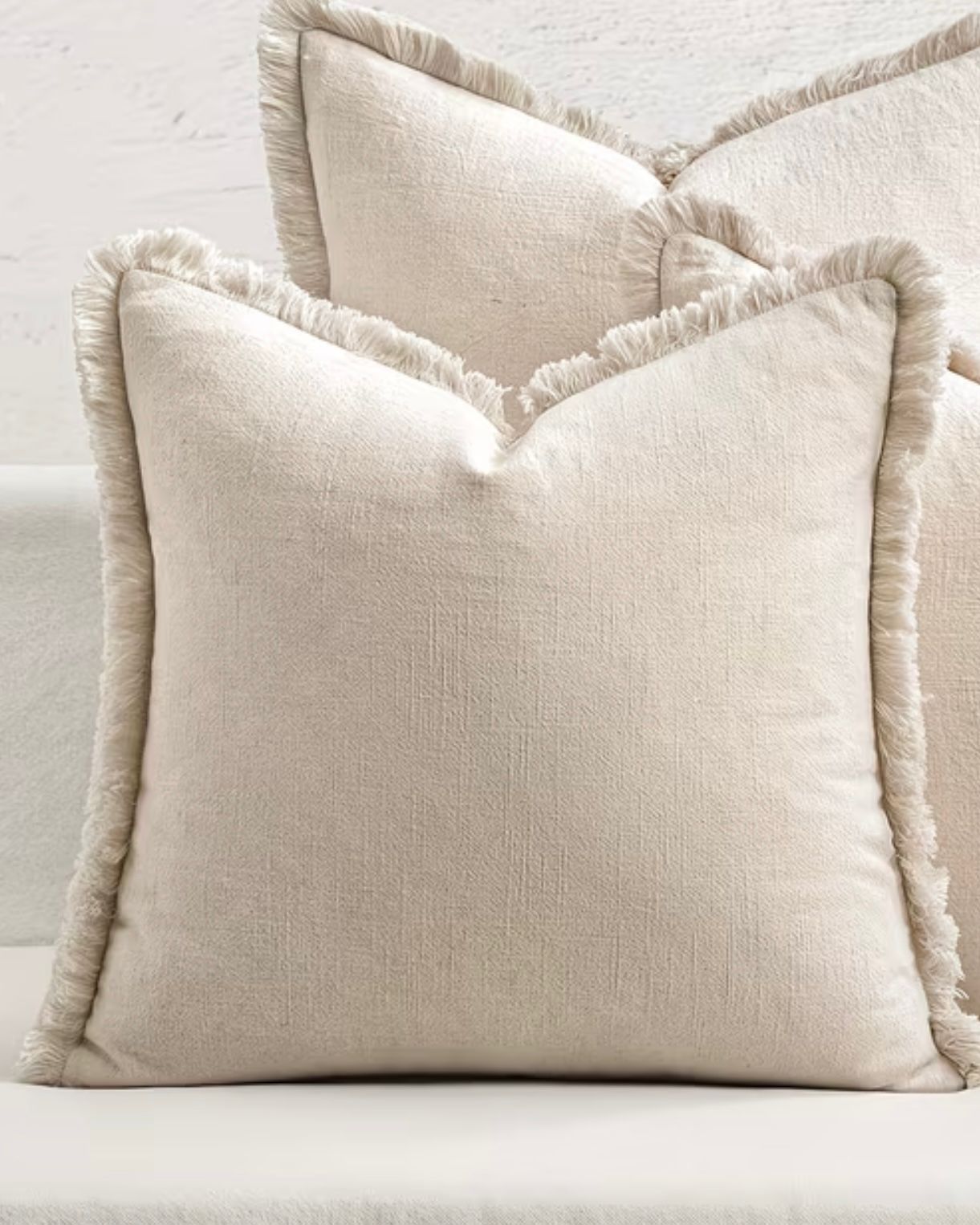 Neutral frayed edge cushion cover by Starlight Express, featuring soft furnishings with a relaxed, textured design.