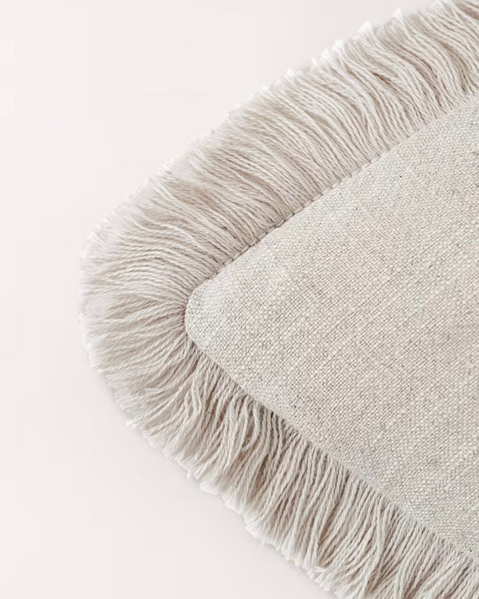 Starlight Express neutral cushion cover with frayed edge detail, made of soft furnishings fabric, displayed on a neutral background.