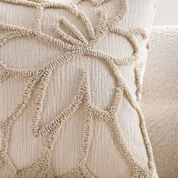 Beige flower embroidered boucle cushion cover from Starlight Express, soft furnishings with floral embroidery and textured boucle fabric.