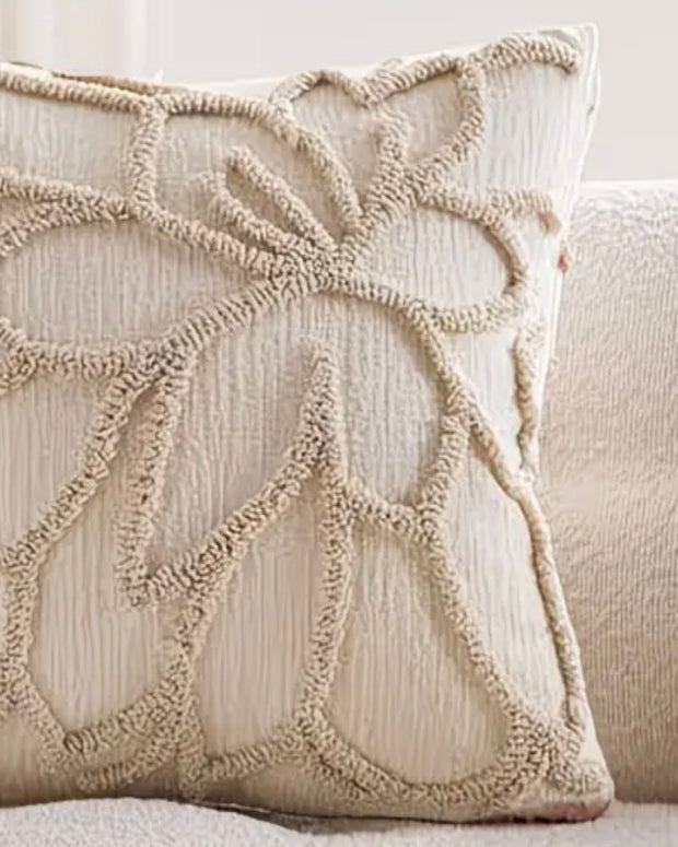 Beige flower embroidered boucle cushion cover from Starlight Express, soft furnishings with floral embroidery and textured boucle fabric.