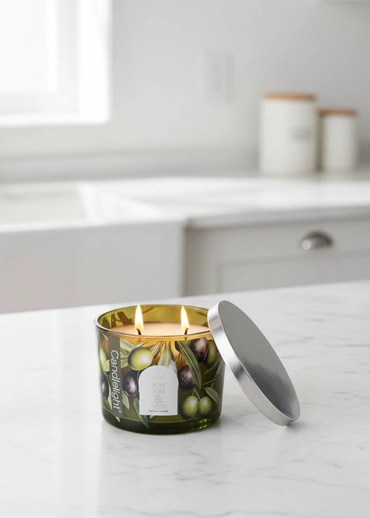 Olive vine and thyme scented candle with metal lid by Candlelight Products Ltd, showing the candle in a glass jar.
