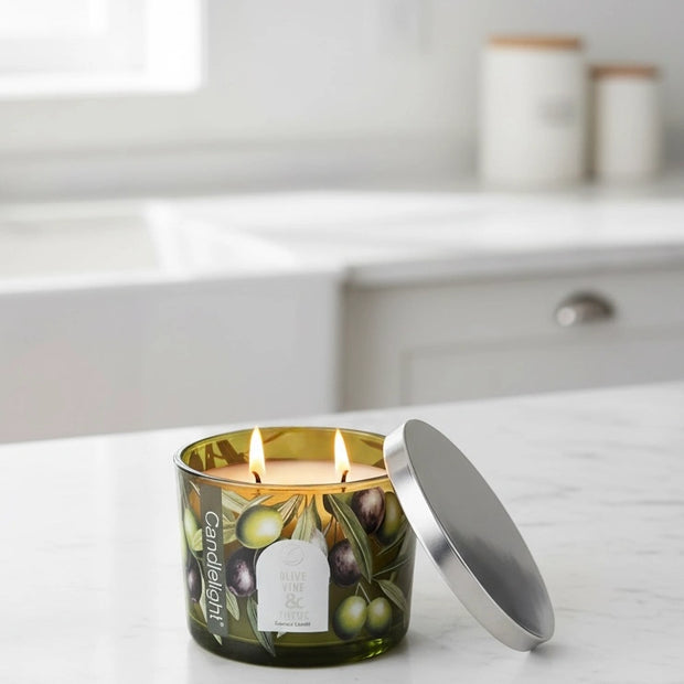 Olive vine and thyme scented candle with metal lid by Candlelight Products Ltd, showing the candle in a glass jar.